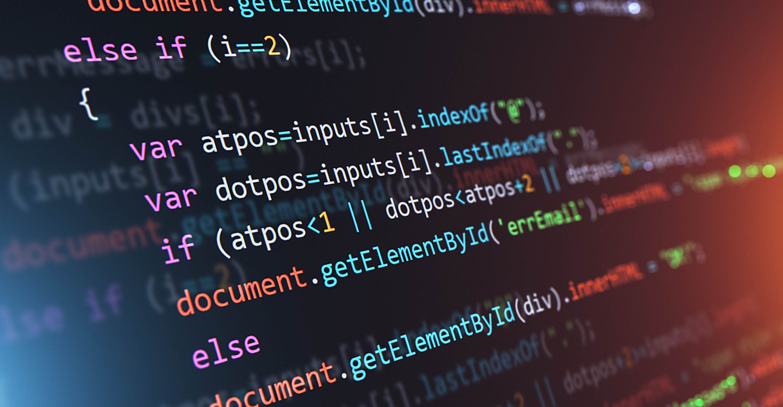 Close-up of colorful lines of code on a computer screen showing JavaScript syntax with various functions, variables, and conditional statements highlighted.