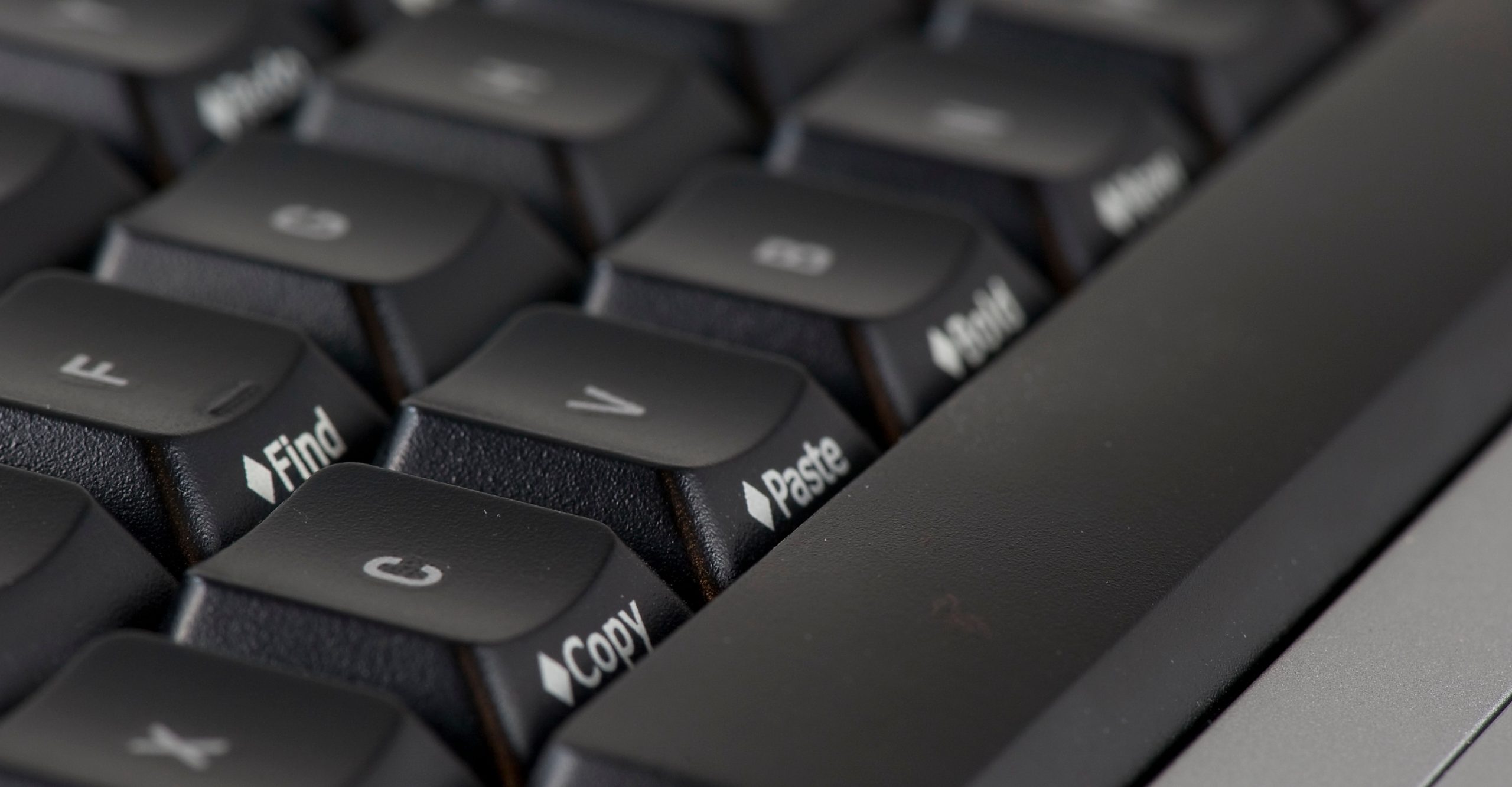 Close-up of a black computer keyboard with prominent "Find," "Copy," and "Paste" keys visible, highlighting how to paste with ease.