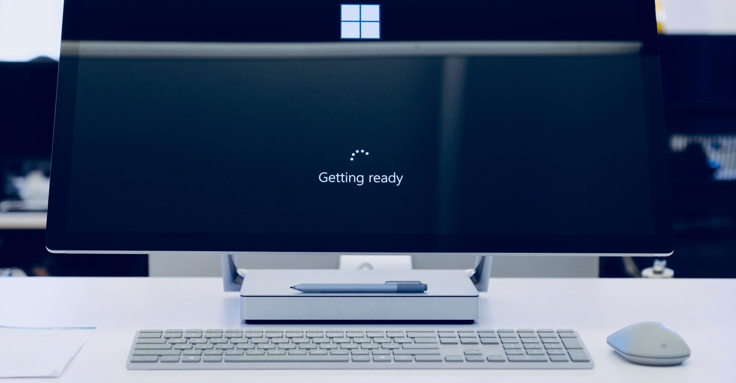 A computer monitor displaying the message "Getting ready" with the Windows logo hints at a New Commerce Experience awaiting users.