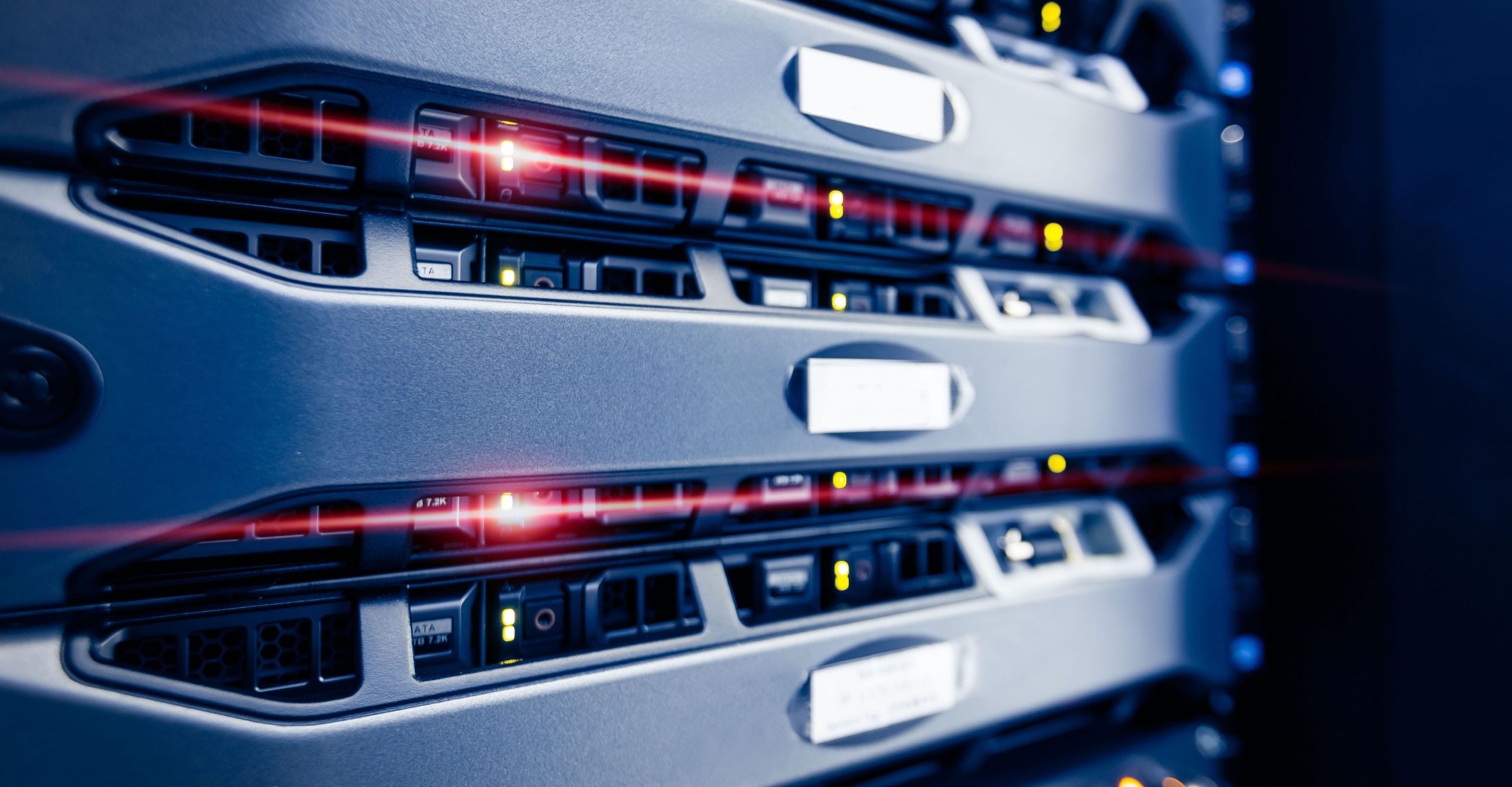 Close-up of server racks with illuminated red and green indicator lights, showing active status in an on-premises storage data center environment.